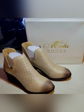Women's 7.5 Mata perforated ankle booties.two-toned tan and cream color scheme.